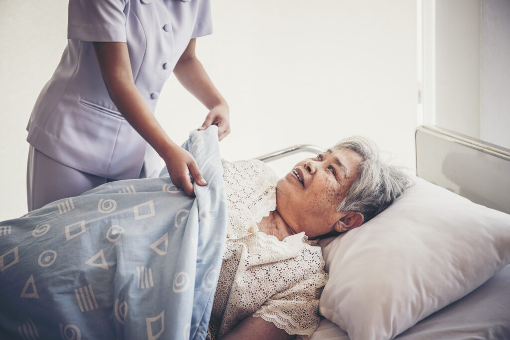 caregiver taking care of elderly patient at the hospital